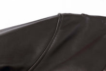 Load image into Gallery viewer, Close-up of REED Men's New Zealand lambskin leather jacket showcasing premium black leather texture and stitching.