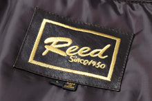Load image into Gallery viewer, REED label on premium leather aviator bomber jacket, showcasing brand and craftsmanship. Made in China, classic style since 1950.