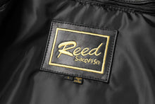 Load image into Gallery viewer, Interior label of REED Men's New Zealand Lambskin Leather Jacket showing brand logo and size.