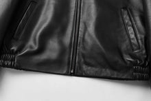 Load image into Gallery viewer, Close-up of REED Men's black New Zealand lambskin leather jacket showing zipper and pockets