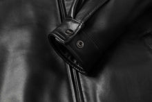 Load image into Gallery viewer, Close-up of black REED Men's New Zealand lambskin leather jacket cuff and zipper detailing for style and comfort.