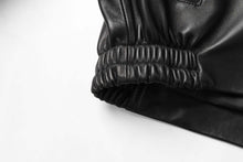 Load image into Gallery viewer, Detail of REED Men's New Zealand Lambskin Leather Jacket, showing black elastic cuff for style and comfort.
