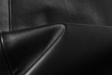 Load image into Gallery viewer, Close-up of black lambskin leather fabric on a REED Men's Jacket, showcasing its smooth and soft texture.