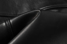 Load image into Gallery viewer, Close-up of black lambskin leather texture from a men's REED jacket, showcasing its luxurious softness and premium quality.