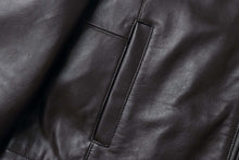 Load image into Gallery viewer, Close-up of REED men's lambskin leather jacket with soft texture and pocket detail, luxury outerwear with stand-up collar.