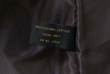 Load image into Gallery viewer, Close-up of a professional leather cleaning label inside a REED men's lambskin leather jacket.