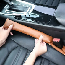 Load image into Gallery viewer, Installing a PU Leather Pad Seat Leakproof Filler in car's seat gap to prevent small items from slipping through.