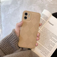 Cargar imagen en el visor de la galería, Person holding phone with Retro Leather Case in diamond pattern, soft PU vegan leather, stylish and protective.