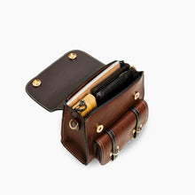 Cargar imagen en el visor de la galería, Interior view of Bumblebee vegan leather backpack with compartments holding various items like a notebook, wallet, and umbrella.