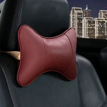 Load image into Gallery viewer, PU leather car neck pillow on a car seat at night, providing head support and comfort for long drives, in vegan leather design.
