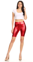 Charger l'image dans la galerie, Shiny metallic red bike shorts with stretchy fit, unisex design, modeled by a person wearing a white top and heels. Made in USA.