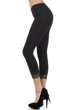 Load image into Gallery viewer, Black cotton blend stretch capri leggings with lace trim, side view worn with high heels, perfect for yoga, pilates, casual wear - Made in USA