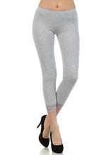 Load image into Gallery viewer, Model wearing gray cotton blend lace trim stretch capri leggings, perfect for yoga or casual wear. Made in USA.