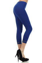 Load image into Gallery viewer, Model wearing blue cotton blend lace trim stretch capri leggings, perfect for yoga or casual wear, with black heels.