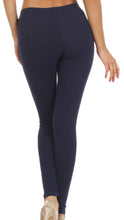 Charger l'image dans la galerie, Back view of woman wearing navy blue cotton blend footless leggings, showing stretch and fit, Made in USA.