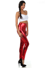 Charger l'image dans la galerie, Model wearing shiny red liquid metallic high waist stretch leggings, made in USA, paired with white tank top and black heels.