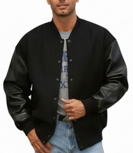 Load image into Gallery viewer, Man wearing a black varsity jacket on a white background
