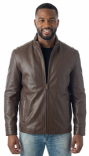Load image into Gallery viewer, Man wearing a brown leather jacket and blue jeans on a white background