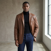 Load image into Gallery viewer, Man wearing a brown leather jacket, black turtleneck, and blue pants in a room with a window.