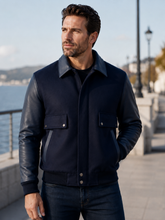 Load image into Gallery viewer, Men's Navy leather varsity bomber jacket with wool body and leather sleeves, modeled by a man. Made in USA, classic and stylish design.