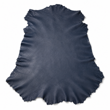 Cargar imagen en el visor de la galería, Navy reed sheepskin hides over a white background