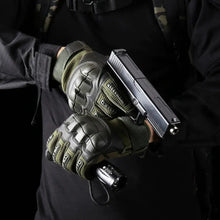 Load image into Gallery viewer, Person wearing full-finger knuckle reinforced tactical gloves holding a flashlight and gun, showcasing durability and protection.