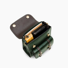 Cargar imagen en el visor de la galería, Open green vegan leather backpack showing organized compartments with accessories inside.