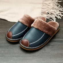 Load image into Gallery viewer, Men's vegan leather slippers with warm faux fur lining, stylish design, and durable sole on wooden floor, ideal for cozy nights.