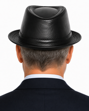 Load image into Gallery viewer, Rear view of a man wearing a black fedora hat, dark suit jacket, and white collared shirt against a plain white background.