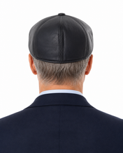 Load image into Gallery viewer, Rear view of a man wearing a black leather kippah cap and a dark navy suit jacket against a white background.