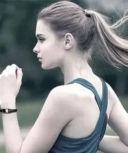Cargar imagen en el visor de la galería, Woman jogging while wearing a USB leather charging braided bracelet, showcasing a blend of style and functionality.