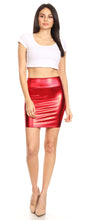 Load image into Gallery viewer, Woman wearing metallic red shiny stretchy short pencil party skirt, paired with a white crop top and heels, front view.