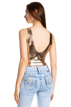 Load image into Gallery viewer, Woman wearing a metallic gold leotard style top paired with blue jeans, showcasing a fashionable and stylish look from behind.