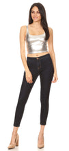 Charger l'image dans la galerie, Model wearing stretchy sleeveless liquid metallic silver crop tank top, paired with dark skinny jeans and nude heels.