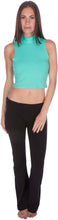 Load image into Gallery viewer, Model wearing aqua mock neck sleeveless scuba crop top with black pants, showcasing modern fashion style.