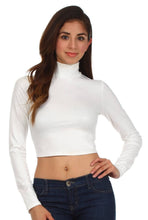 Load image into Gallery viewer, Woman wearing a white matte liquid mock neck turtleneck long sleeve crop top, made in USA, paired with blue jeans.