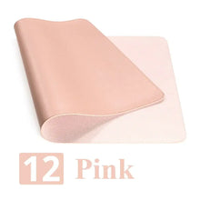 Load image into Gallery viewer, Pink leather suede desk mat, rolled at corner, showcasing durability and style for workspace enhancement.