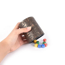 Load image into Gallery viewer, Hand holding Egyptian pattern brown leather rune dice cup with colorful dice.