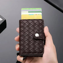 Load image into Gallery viewer, Hand holding brown woven leather RFID cardholder with credit cards visible, compact stylish wallet for protection against electronic theft.