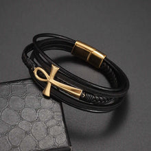 Cargar imagen en el visor de la galería, Classic multi-layered vegan leather bracelet with gold ankh charm on a textured surface.