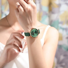 Load image into Gallery viewer, Woman wearing a Classic Clock Leather Watch with elegant design and green strap, showcasing its stylish and fashionable appeal.