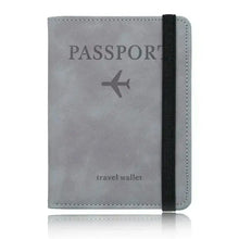 Load image into Gallery viewer, Gray leather passport holder with RFID blocking, featuring travel-themed embossing and elastic band for secure closure.