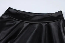 Cargar imagen en el visor de la galería, Close-up of faux leather fabric on a ruched mini dress, showcasing its sleek and sophisticated design.