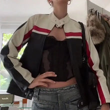 Charger l'image dans la galerie, Model wearing a patchwork vegan leather jacket with red and white stripes, showcasing a bold fashion style indoors.