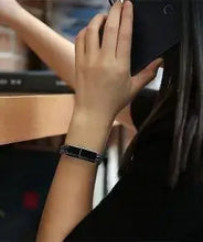 Cargar imagen en el visor de la galería, Person wearing a USB leather charging braided bracelet while talking on the phone, showcasing sleek style and portable charging.