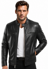 Load image into Gallery viewer, A man wearing a black leather motorcycle jacket over a white t-shirt and black pants, photographed against a solid white background.