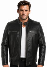 Load image into Gallery viewer, A man wearing a black leather motorcycle jacket over a white t-shirt and black pants, photographed against a solid white background.