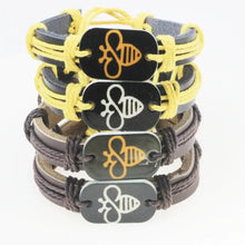 Cargar imagen en el visor de la galería, Stack of handmade leather bracelets with bee motifs in yellow and brown designs, showcasing unique artisanal craftsmanship.
