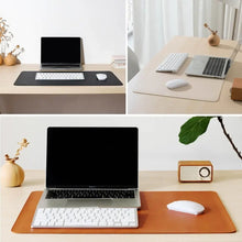 Load image into Gallery viewer, Elegant leather suede desk mat enhancing workspace with style and protection, featuring laptop, keyboard, and mouse on wooden desk.