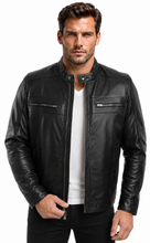 Load image into Gallery viewer, A man wearing a black leather motorcycle jacket over a white t-shirt and black pants, standing against a plain white background.